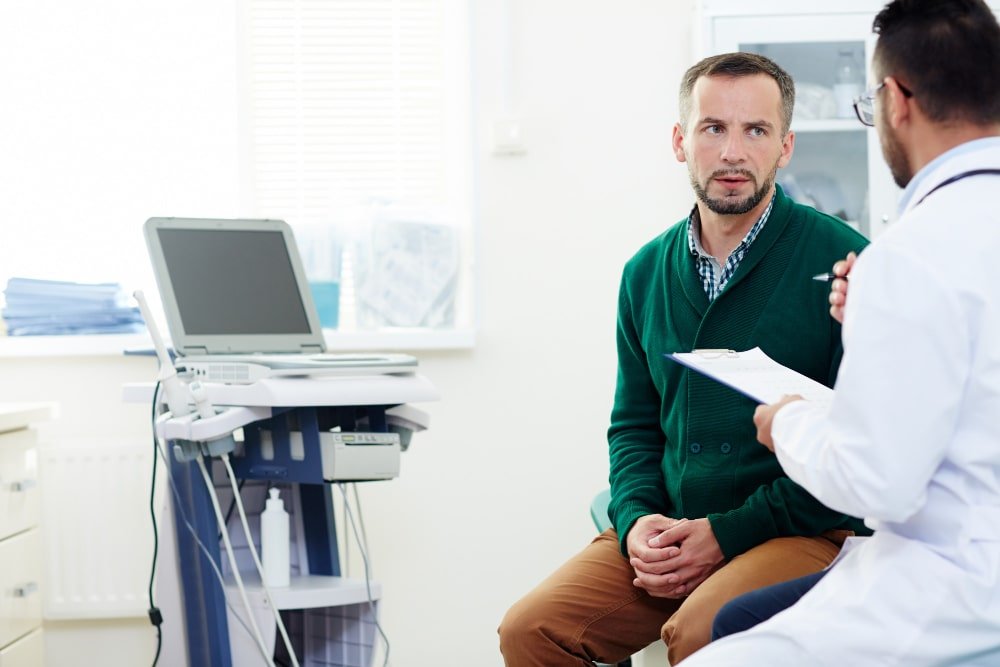 Rancho, California clinic with a doctor reviewing diagnostic results with a male patient near a portable ultrasound machine.