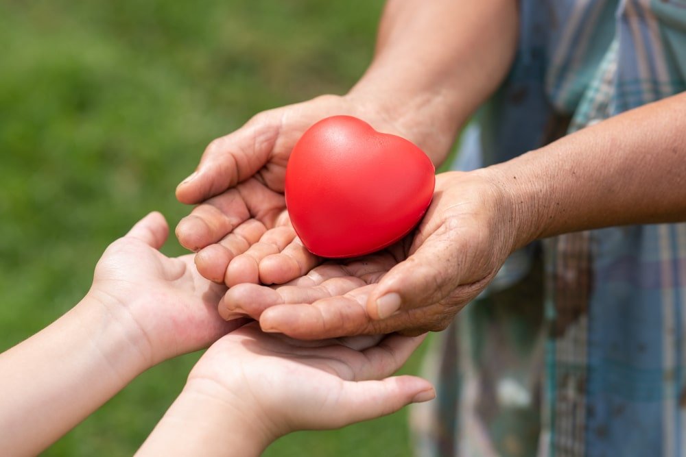 Rancho, California park with an adult and child holding a small red heart.